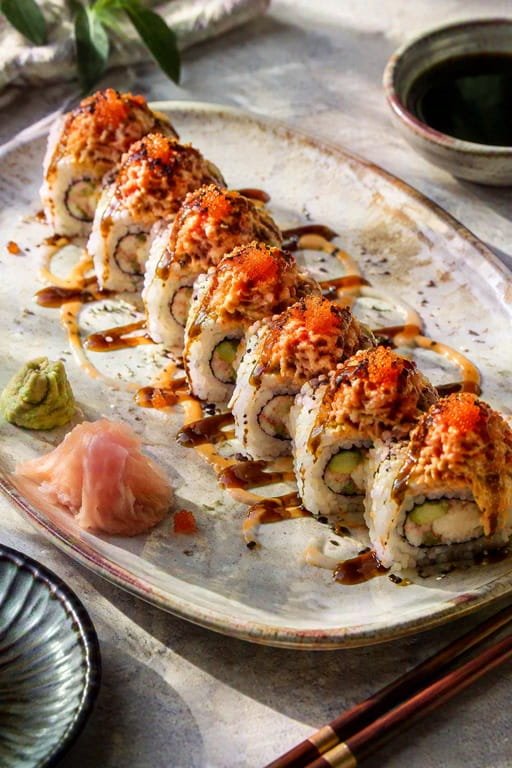 Angry Dragon Roll recipe plated with soy sauce, wasabi, and pickled ginger