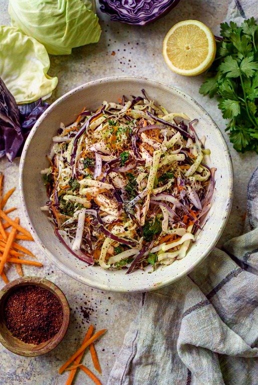 A bowl of CAVA cabbage slaw made with red cabbage, green cabbage, and herbs.