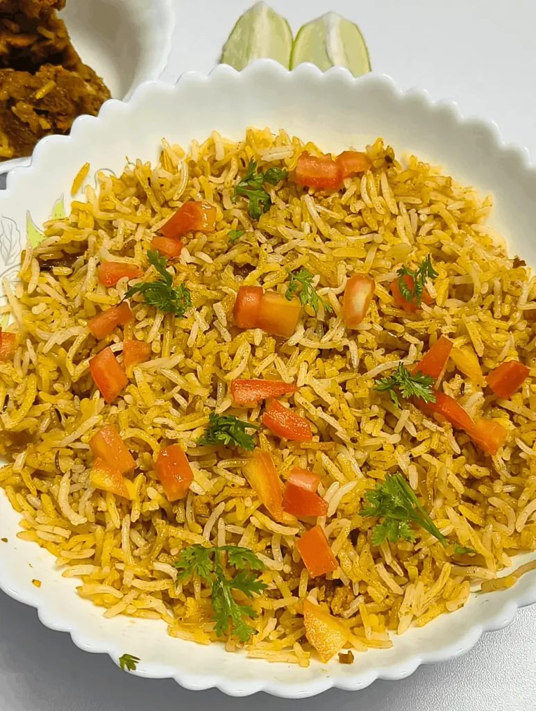 Angled view of Cava Saffron Basmati Rice with garnish and lime wedges