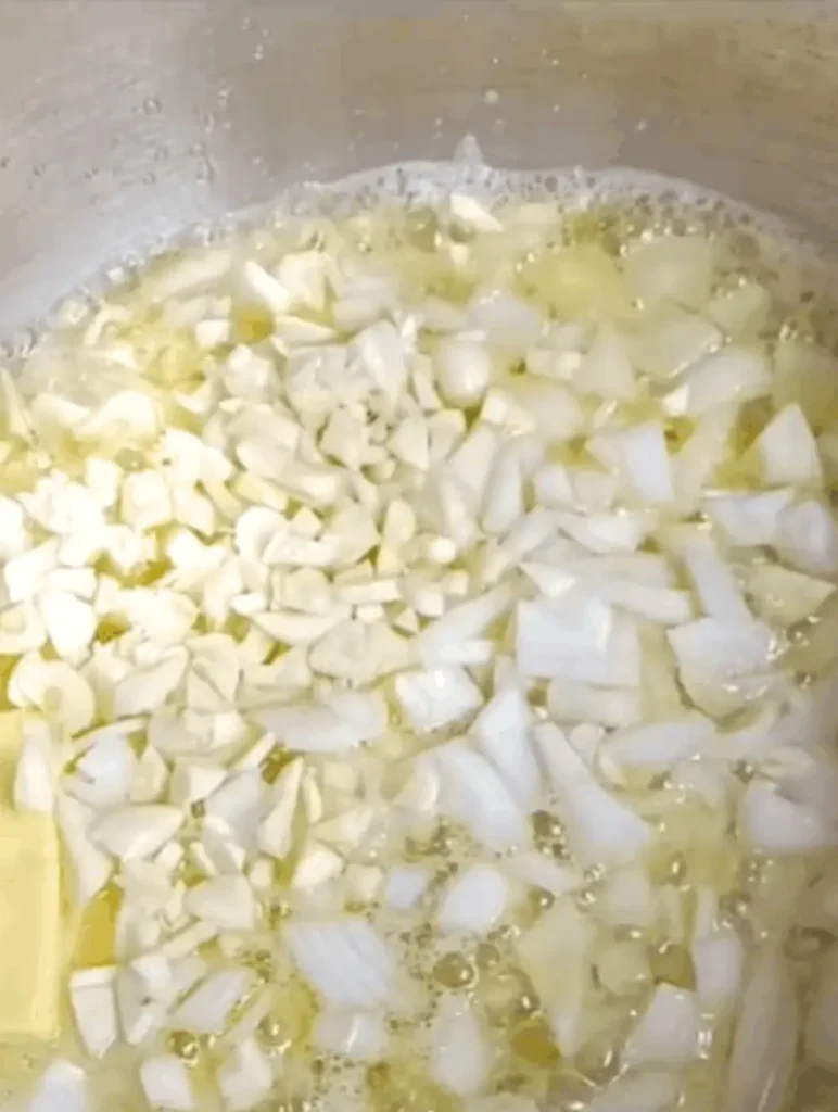 Chopped onion and garlic cooking in oil