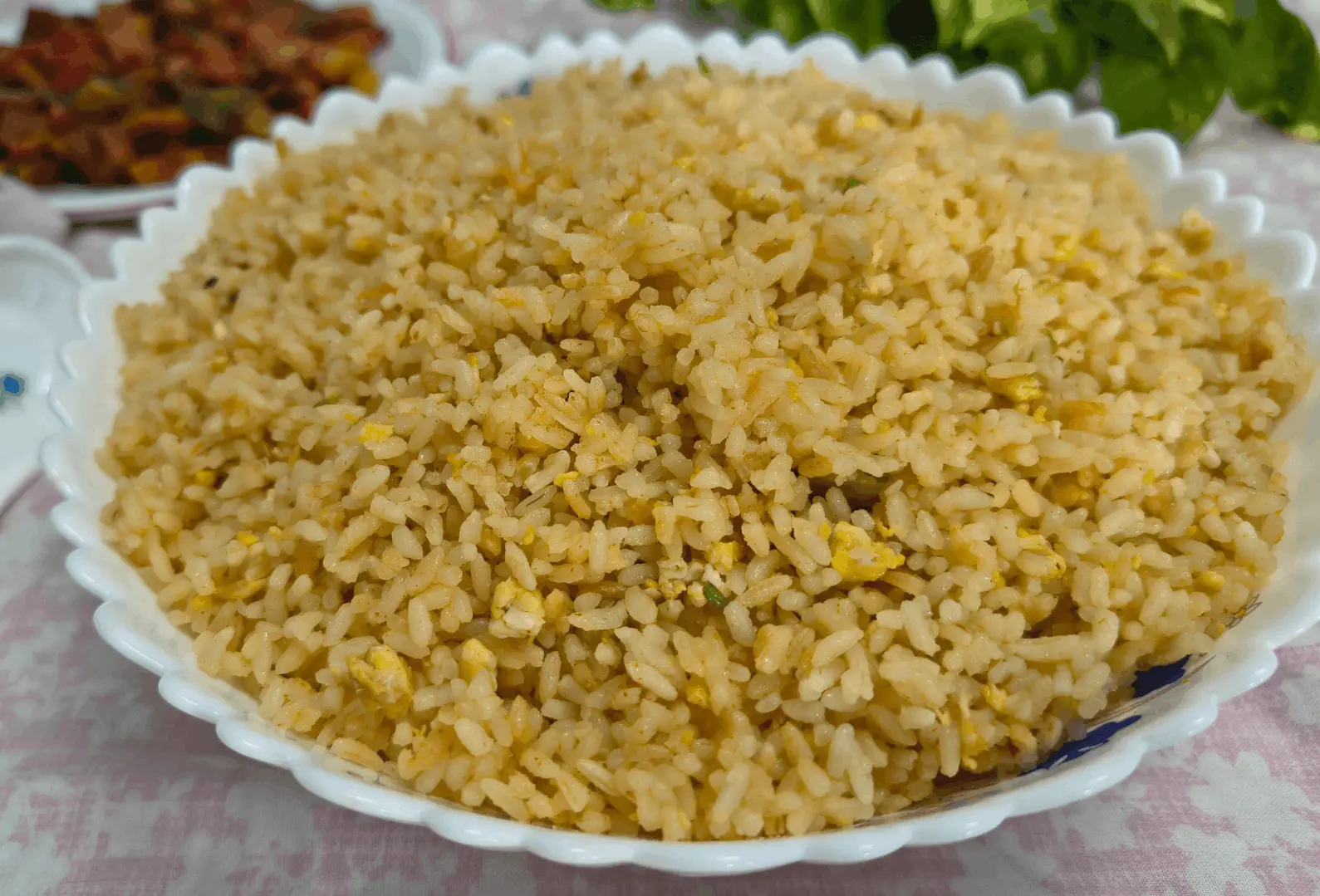 Plate of egg fried brown rice with scrambled egg and green and red pepper, a Cava brown rice variation