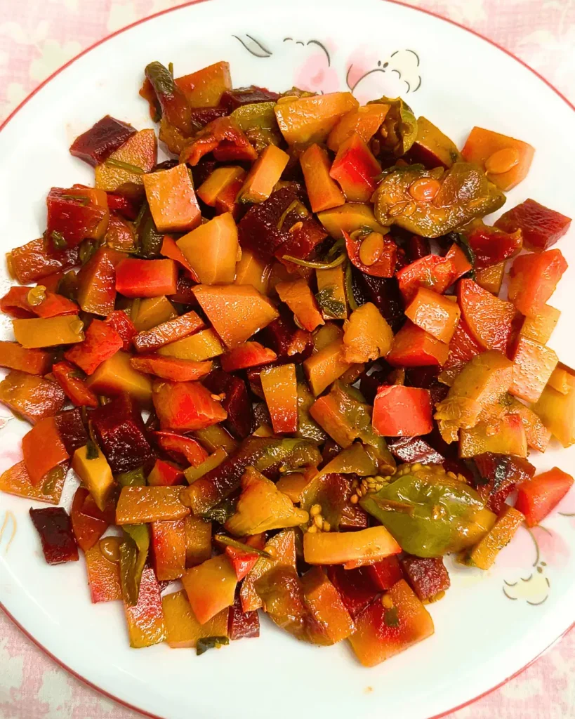 Overhead view of a white plate filled with colorful diced CAVA roasted vegetables.