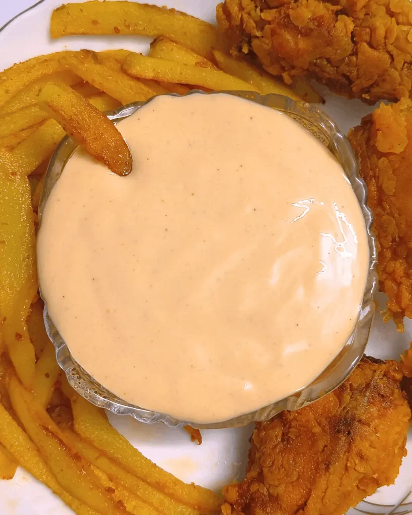 Top view of Sonic Groovy Sauce in a glass bowl with a golden fry dipped in the creamy sauce